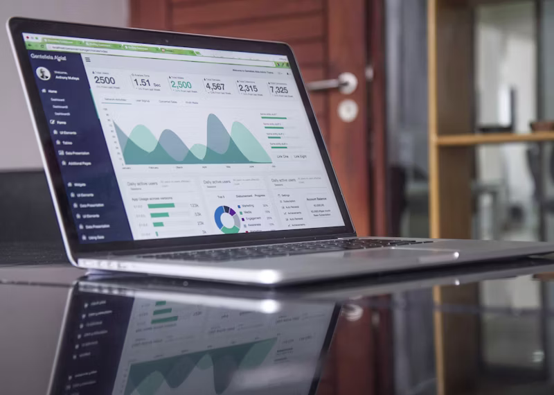 Spreadsheet statistics charts on a laptop